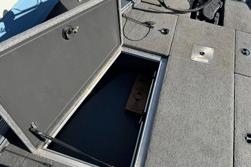 Slide: The Image of Open storage compartment on 2018 Lund 1875 Pro-V Bass boat deck. - 19