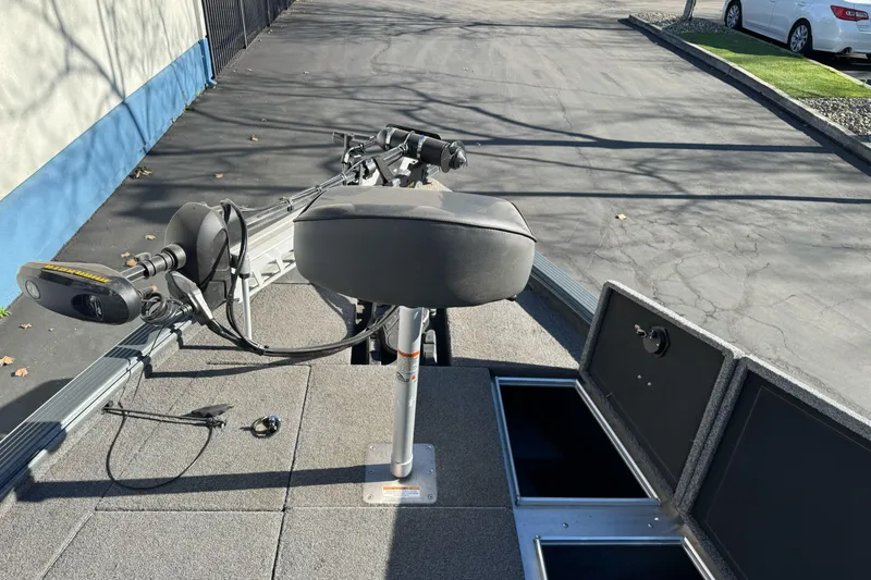 Slide: The Image of 2018 Lund 1875 Pro-V Bass boat deck with seat and storage compartments. - 21