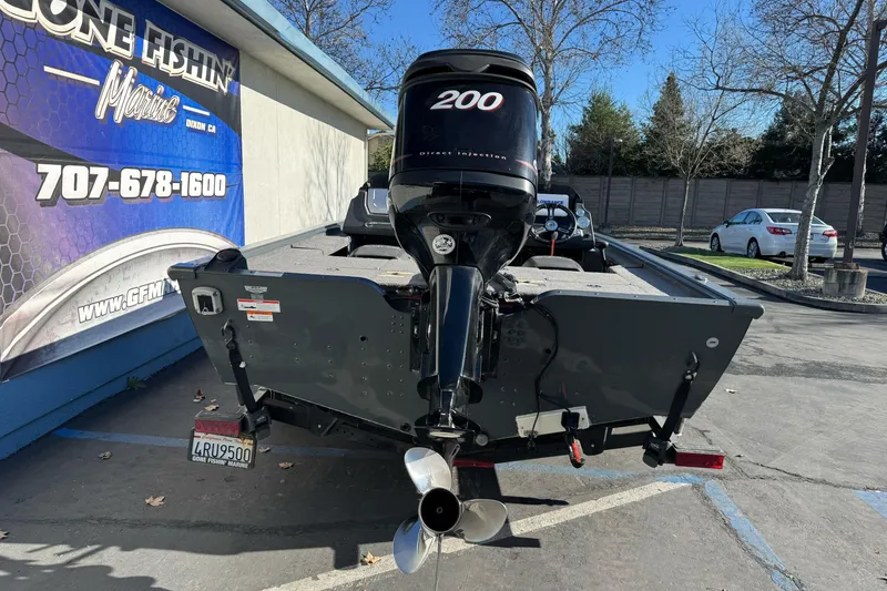 Slide: The Image of 2018 Lund 1875 Pro-V Bass boat with 200 HP engine in parking lot. - 3