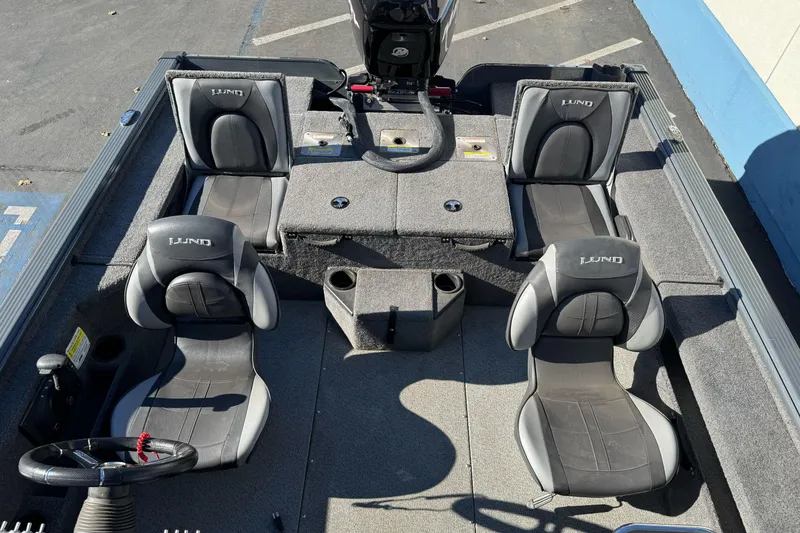 Slide: The Image of 2018 Lund 1875 Pro-V Bass boat interior with four seats and steering wheel. - 6