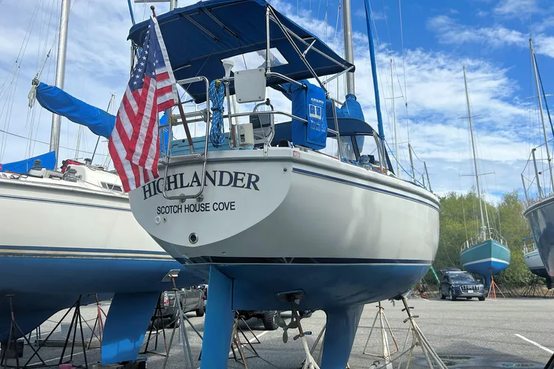 Slide: The Image of 1981 Catalina 30 sailboat "Highlander" in dry dock with American flag. - 13