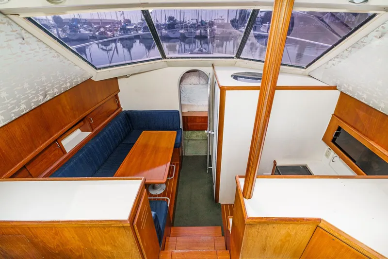 Slide: The Image of 1989 Pearson 34 Convertible yacht interior with wood finish and blue seating. - 10