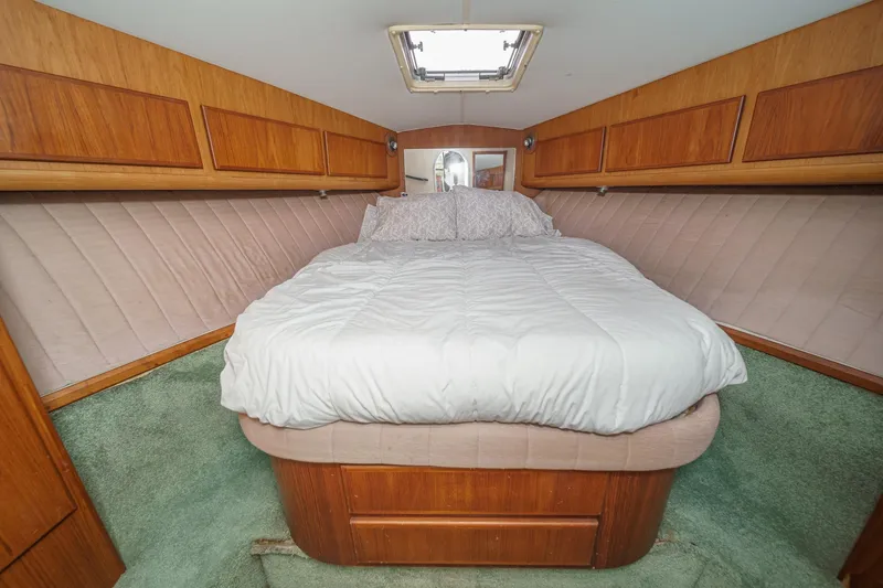 Slide: The Image of Cozy bedroom interior of 1989 Pearson 34 Convertible yacht with wood paneling and skylight. - 15