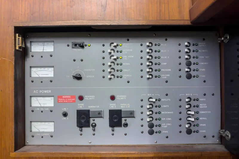 Slide: The Image of Electrical control panel on a 1989 Pearson 34 Convertible boat, featuring various switches and gauges. - 22