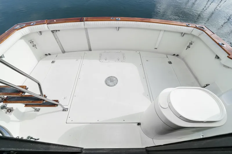 Slide: The Image of 1989 Pearson 34 Convertible boat deck with white seating and wooden accents. - 4
