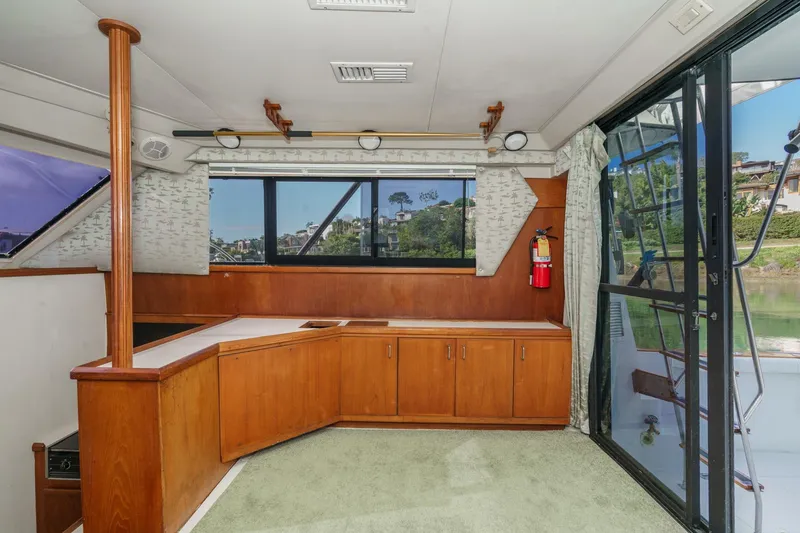Slide: The Image of Interior of 1989 Pearson 34 Convertible yacht with wooden cabinetry and large windows. - 9