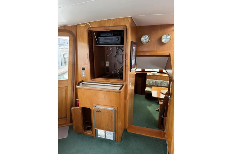 Slide: The Image of 1984 Gulfstar 49 Motor Yacht interior with wood paneling and nautical instruments. - 11