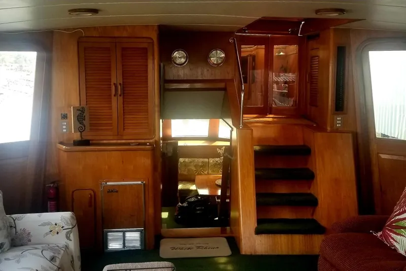 Slide: The Image of 1984 Gulfstar 49 Motor Yacht interior with wooden cabinetry and staircase. - 12