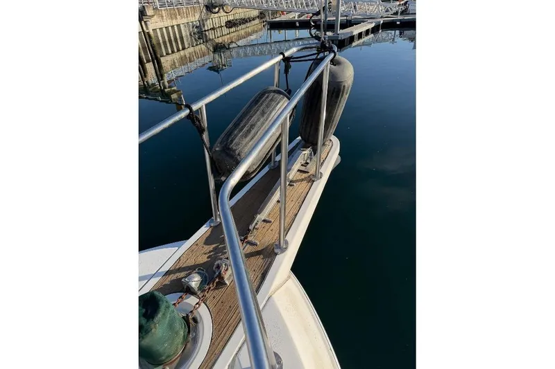 Slide: The Image of 1984 Gulfstar 49 Motor Yacht deck with railings and fenders at a marina. - 17