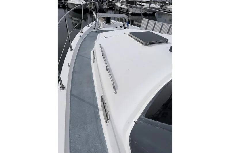 Slide: The Image of 1984 Gulfstar 49 Motor Yacht deck view with railing and hatch. - 19
