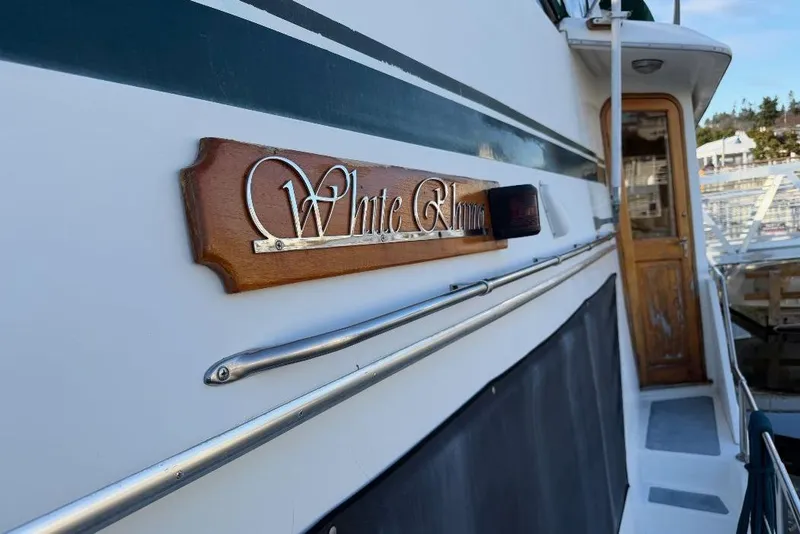 Slide: The Image of 1984 Gulfstar 49 Motor Yacht with wooden nameplate, docked at marina. - 25