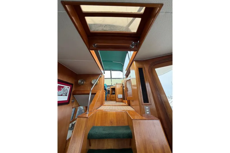 Slide: The Image of Interior view of 1984 Gulfstar 49 Motor Yacht with wooden stairs and skylight. - 27