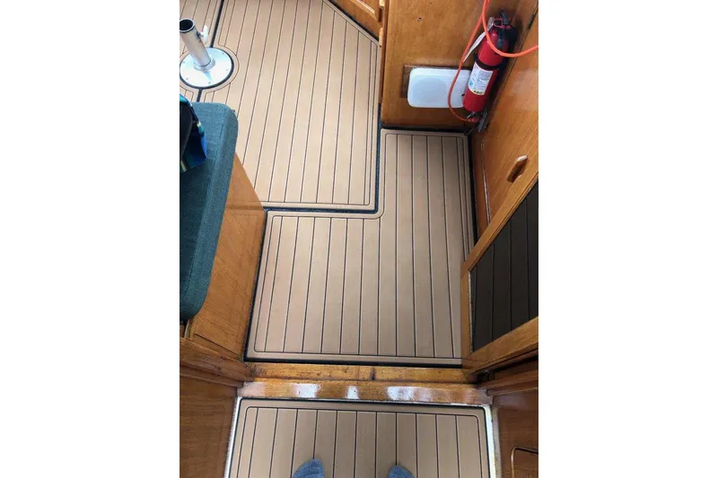 Slide: The Image of 1984 Gulfstar 49 Motor Yacht interior with teak flooring and fire extinguisher. - 28