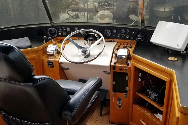 Slide: The Image of 1984 Gulfstar 49 Motor Yacht helm with steering wheel, controls, and navigation equipment. - 32
