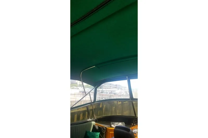 Slide: The Image of Interior view of 1984 Gulfstar 49 Motor Yacht with green canopy and seating area. - 36