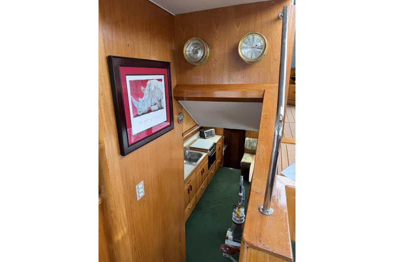Slide: The Image of Interior of 1984 Gulfstar 49 Motor Yacht with wood paneling and kitchen area. - 38
