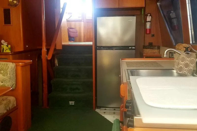 Slide: The Image of Interior of 1984 Gulfstar 49 Motor Yacht with kitchen and stairs. - 39