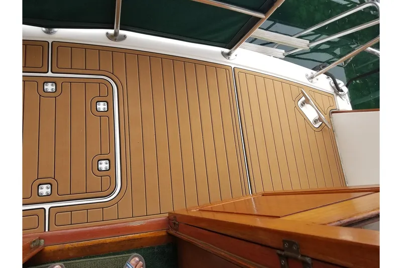 Slide: The Image of 1984 Gulfstar 49 Motor Yacht deck with teak flooring and stainless steel railings. - 4