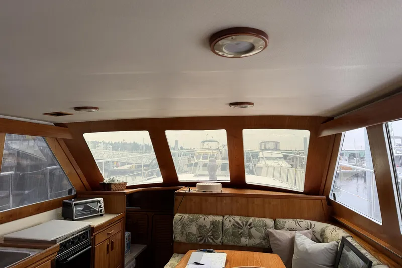 Slide: The Image of Interior of 1984 Gulfstar 49 Motor Yacht with wood finish and marina view. - 40