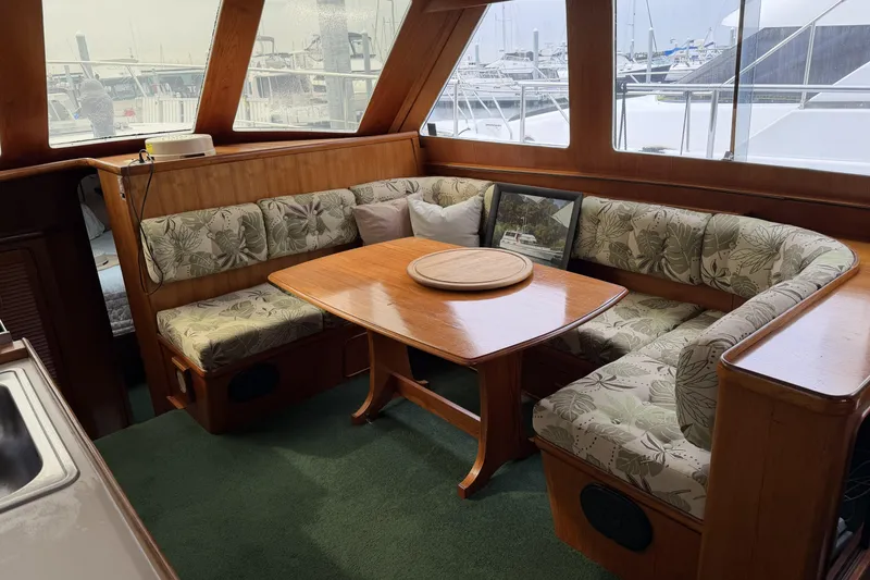 Slide: The Image of Interior of 1984 Gulfstar 49 Motor Yacht with floral upholstery and wooden dining table. - 42