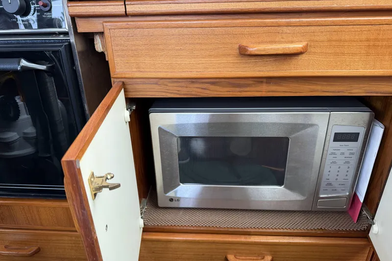 Slide: The Image of Microwave in wooden cabinet on 1984 Gulfstar 49 Motor Yacht kitchen. - 44