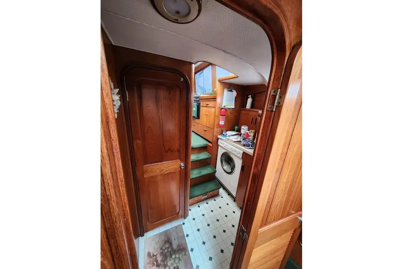 Slide: The Image of Interior of 1984 Gulfstar 49 Motor Yacht with wooden finish and laundry area. - 45