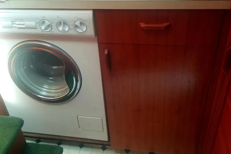 Slide: The Image of Washing machine and wooden cabinet inside 1984 Gulfstar 49 Motor Yacht. - 46