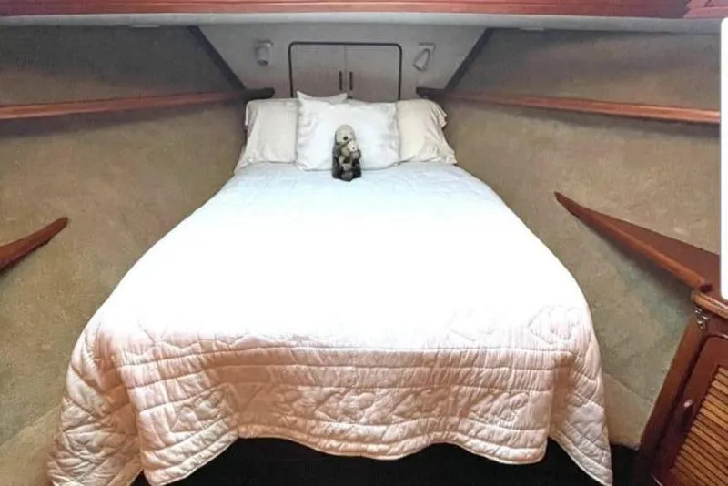 Slide: The Image of Bedroom in 1984 Gulfstar 49 Motor Yacht with white bedding and plush toy. - 48