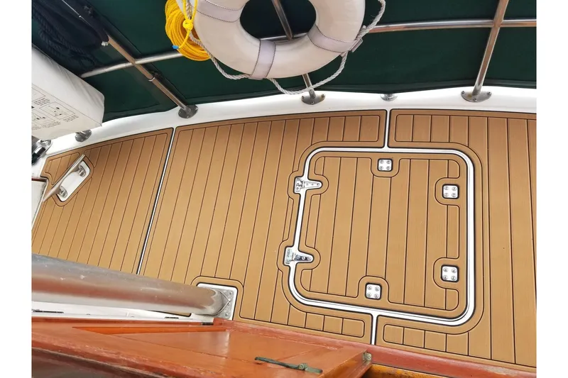 Slide: The Image of 1984 Gulfstar 49 Motor Yacht deck with teak flooring and life preserver. - 5