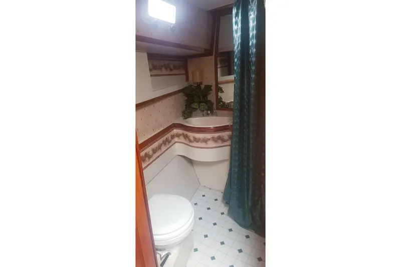 Slide: The Image of 1984 Gulfstar 49 Motor Yacht bathroom with floral wallpaper and green shower curtain. - 50
