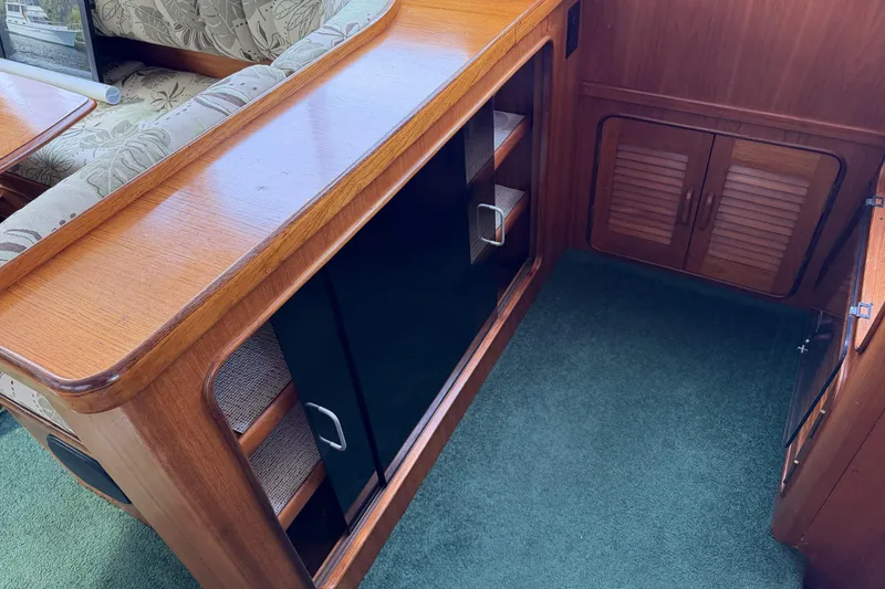 Slide: The Image of Interior of 1984 Gulfstar 49 Motor Yacht with wooden cabinetry and green carpet. - 53