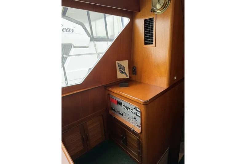Slide: The Image of Interior of 1984 Gulfstar 49 Motor Yacht with wooden cabinetry and nautical decor. - 54