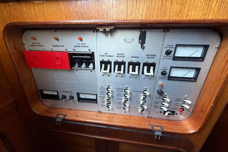 Slide: The Image of Electrical control panel on a 1984 Gulfstar 49 Motor Yacht, featuring various switches and meters. - 56