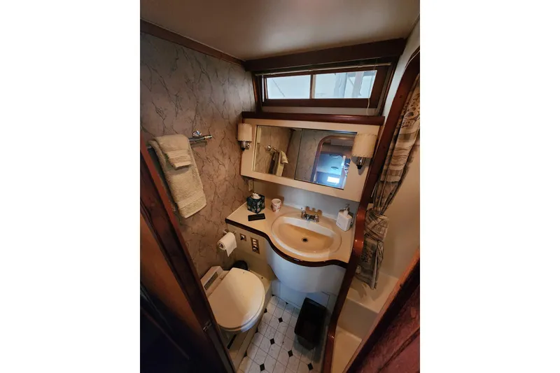 Slide: The Image of 1984 Gulfstar 49 Motor Yacht bathroom with sink, toilet, and mirror. - 58