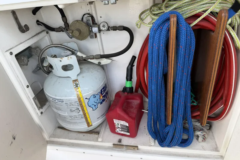Slide: The Image of Storage compartment on a 1984 Gulfstar 49 Motor Yacht with propane tank and ropes. - 6