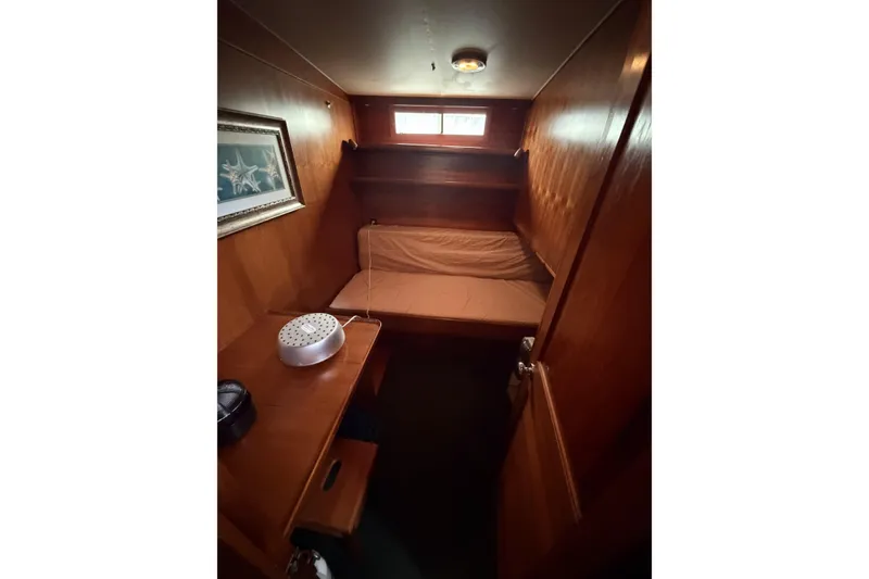 Slide: The Image of Cozy cabin interior of 1984 Gulfstar 49 Motor Yacht with wooden paneling and framed artwork. - 60