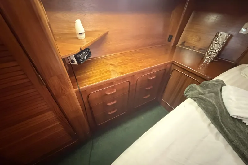 Slide: The Image of 1984 Gulfstar 49 Motor Yacht cabin with wooden cabinetry and cozy bedding. - 64