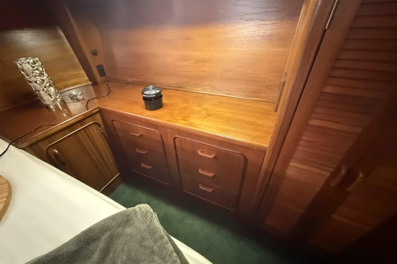 Slide: The Image of Wooden interior of 1984 Gulfstar 49 Motor Yacht with cabinets and decorative vase. - 67