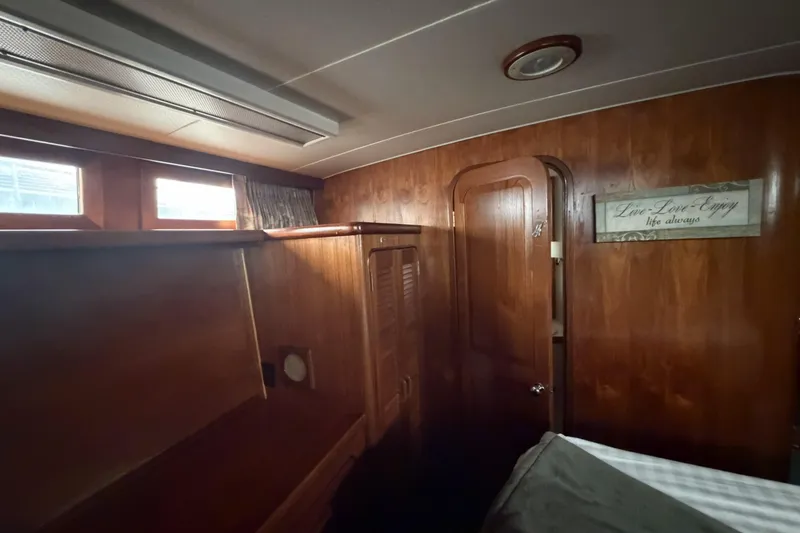 Slide: The Image of Interior of 1984 Gulfstar 49 Motor Yacht with wooden paneling and cozy decor. - 68