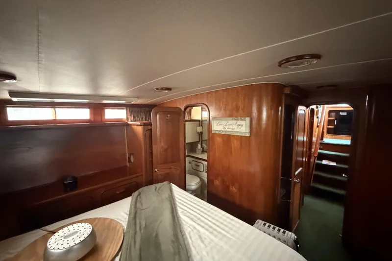 Slide: The Image of 1984 Gulfstar 49 Motor Yacht interior with wood paneling and cozy cabin design. - 69