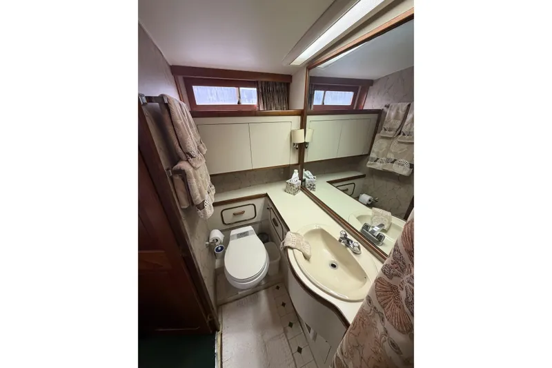 Slide: The Image of Bathroom interior of 1984 Gulfstar 49 Motor Yacht with sink, toilet, and mirror. - 70