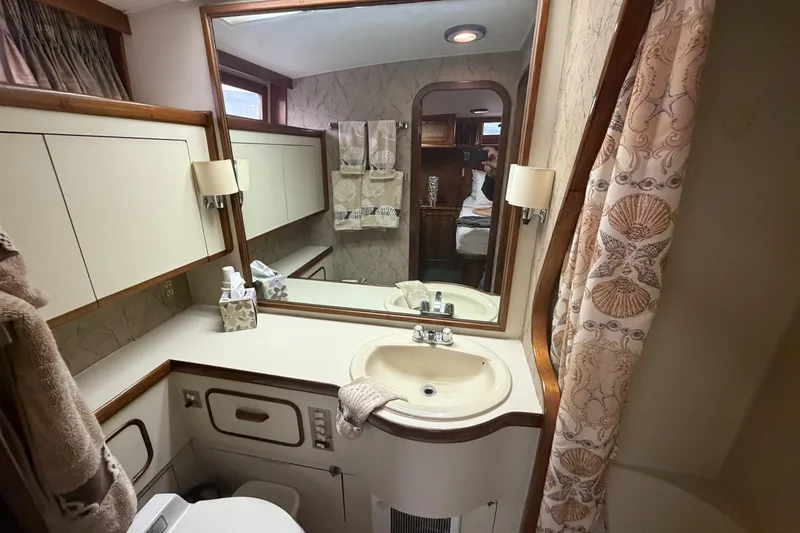 Slide: The Image of Bathroom interior of 1984 Gulfstar 49 Motor Yacht with sink, mirror, and nautical decor. - 71