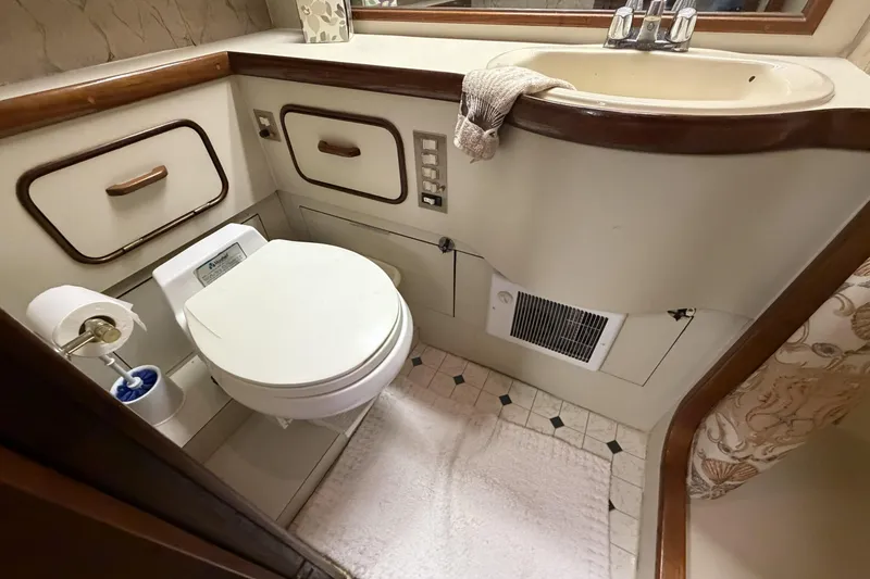 Slide: The Image of 1984 Gulfstar 49 Motor Yacht bathroom with toilet, sink, and storage cabinets. - 72