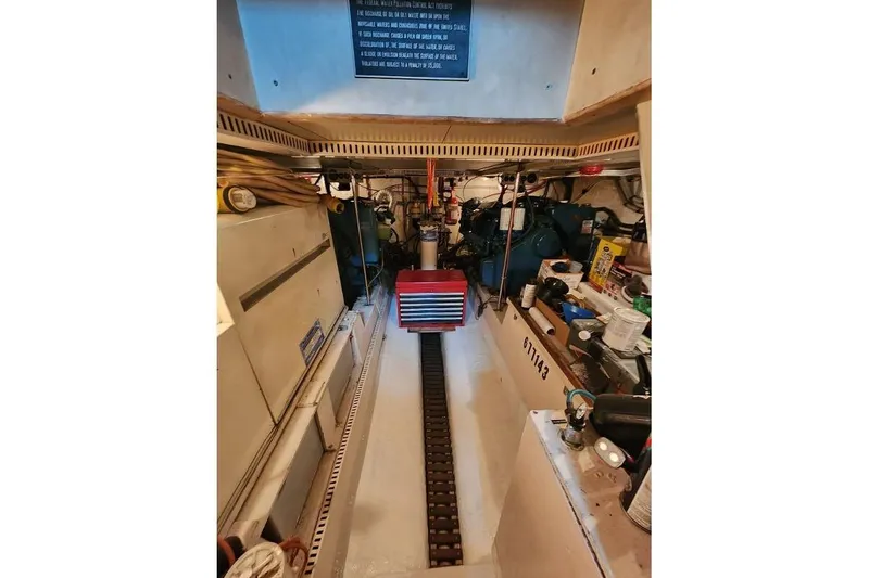 Slide: The Image of Engine room of 1984 Gulfstar 49 Motor Yacht, featuring mechanical components and tools. - 74
