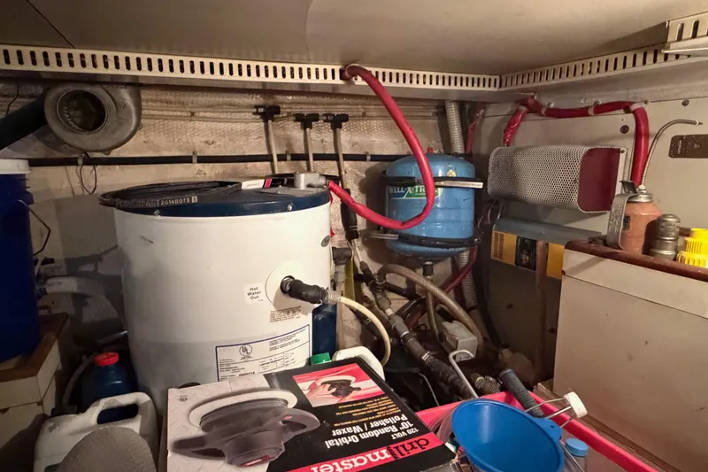 Slide: The Image of Engine room of a 1984 Gulfstar 49 Motor Yacht with various equipment and piping. - 78