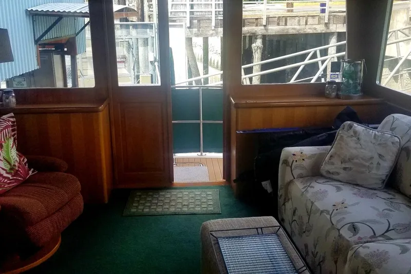 Slide: The Image of Interior of 1984 Gulfstar 49 Motor Yacht with cozy seating and wooden accents. - 8