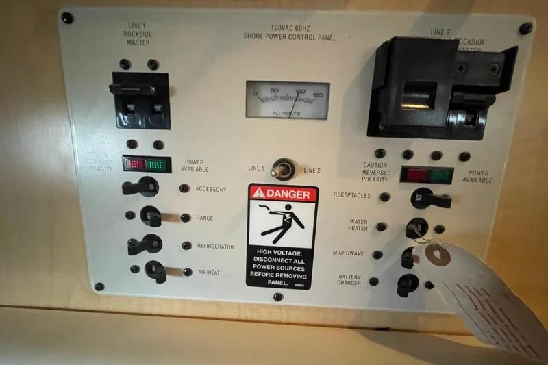 Slide: The Image of Control panel of a 2000 Bayliner 2655 Ciera Sunbridge boat, showing power switches and warnings. - 11