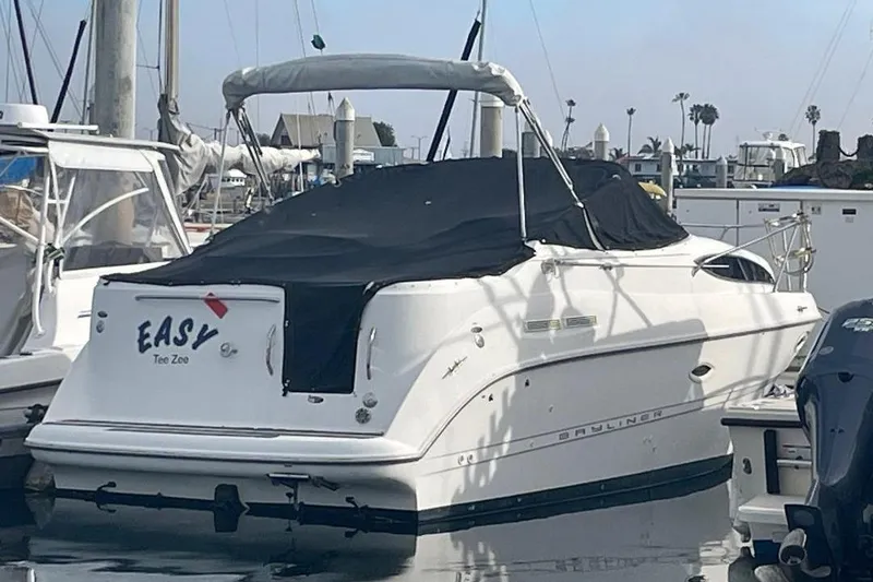 Slide: The Image of 2000 Bayliner 2655 Ciera Sunbridge boat docked with black cover. - 17