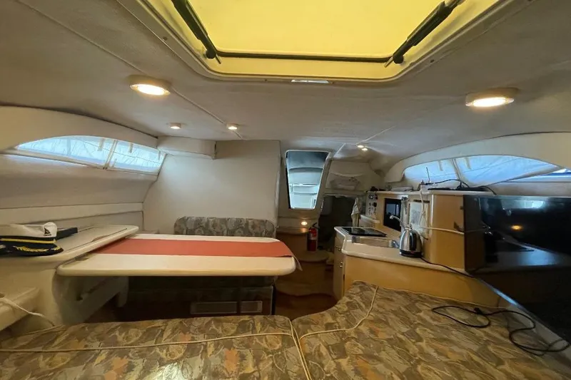 Slide: The Image of Interior of 2000 Bayliner 2655 Ciera Sunbridge, featuring dining area and kitchenette. - 5