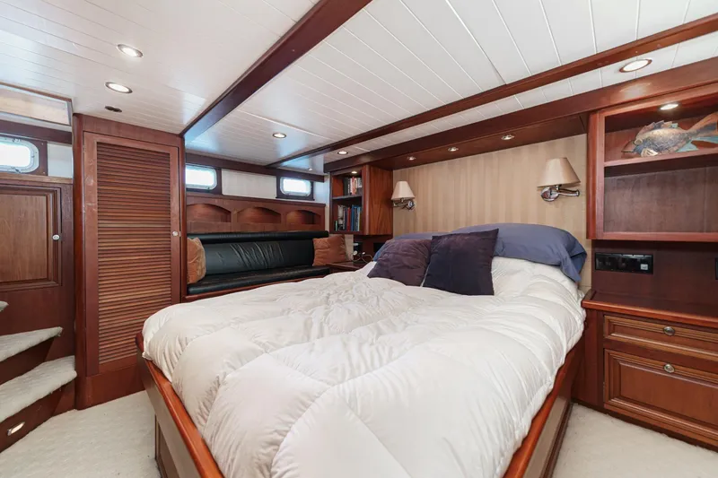 Slide: The Image of Luxurious 1963 DeFever Custom yacht bedroom with wood paneling and cozy bedding. - 12